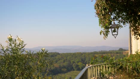 balcony of a country house with views of the provencal countryside in slowmotion in france with a lot of pot and flowers near the fence