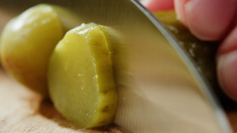 cutting a dill pickle