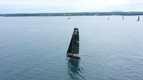 race sailboat sailing in regatta rc44 rovinj croatia - aerial drone view