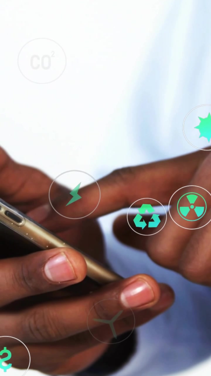 Vertical video: Man tapping gold phone making eco icons circling fingers while viewing energy cost