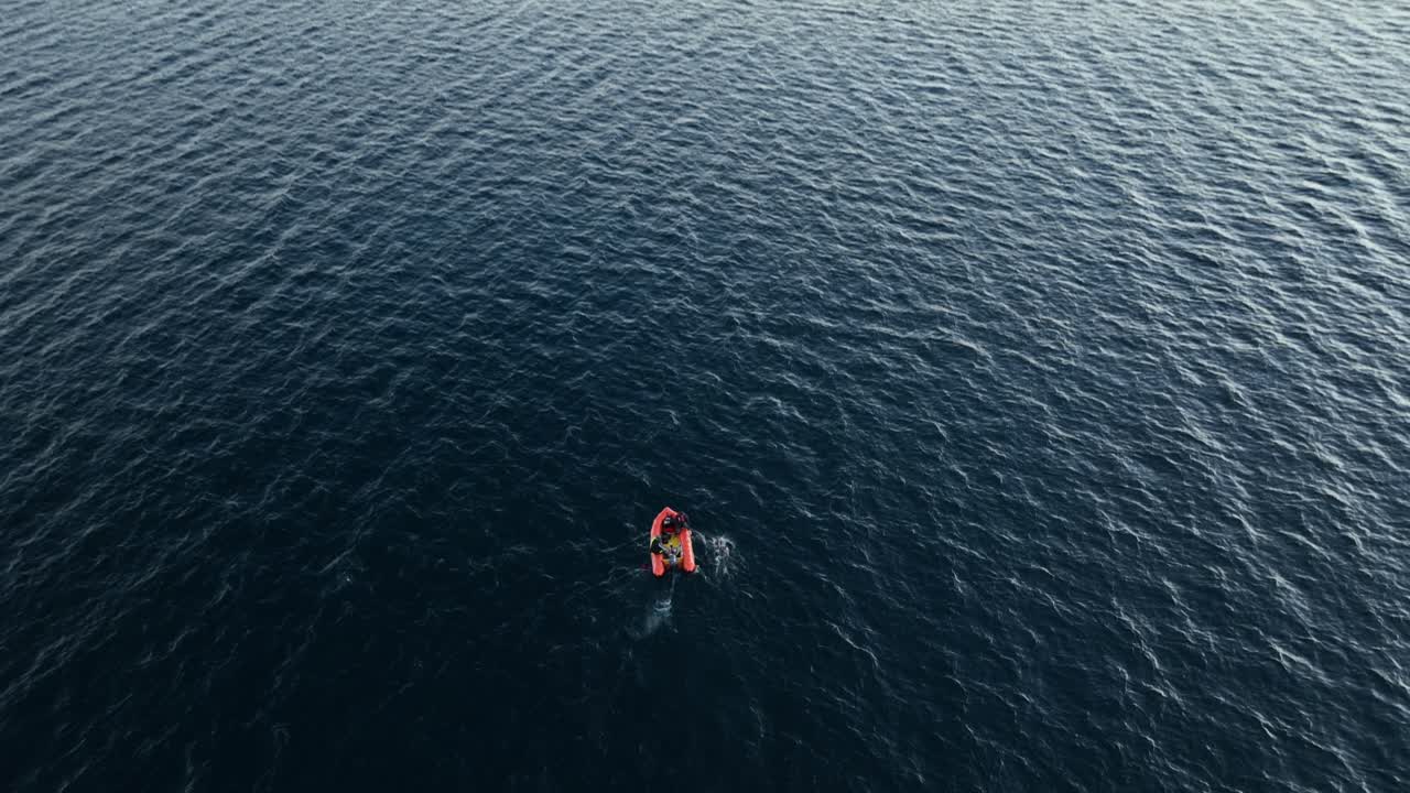 Solo swimmer battling across choppy water as the sun comes up. Crystal clear waters. Athlete. Wide Drone shot