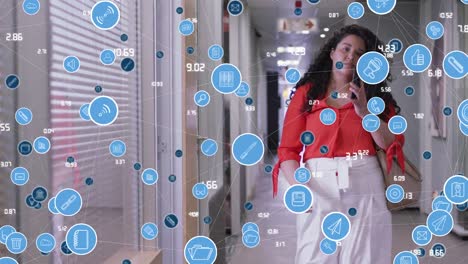 Animación-De-íconos-De-Computadora-Que-Se-Conectan-Con-Líneas-Sobre-Una-Mujer-Birracial-Hablando-Por-Teléfono-Celular-En-La-Oficina