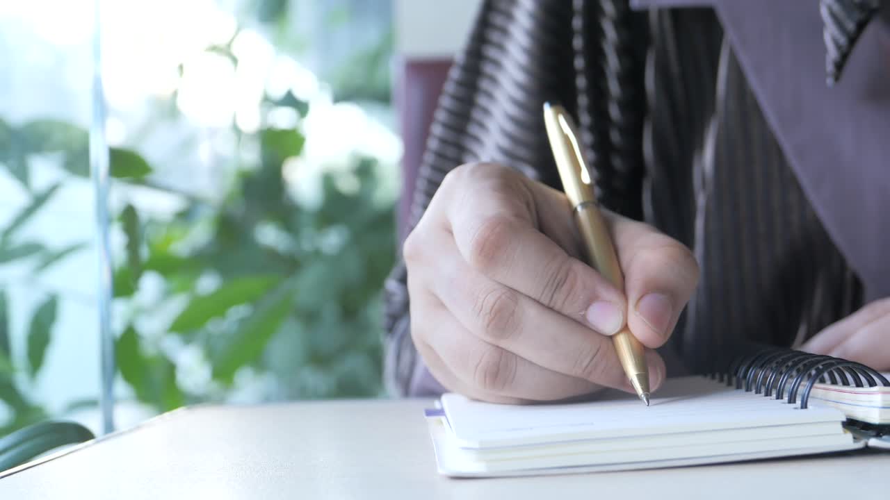 Person taking notes in a coffee shop