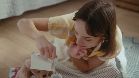 a girl playing with dolls in her room