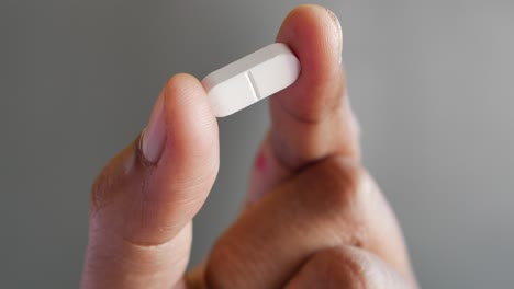 close up of man hand holding pills with copy space