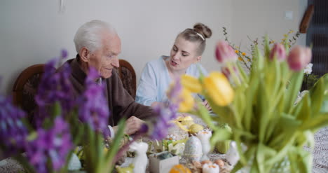 happy easter senior man and young woman conversating during easter holidays