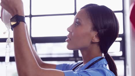nurse examining intravenous drip