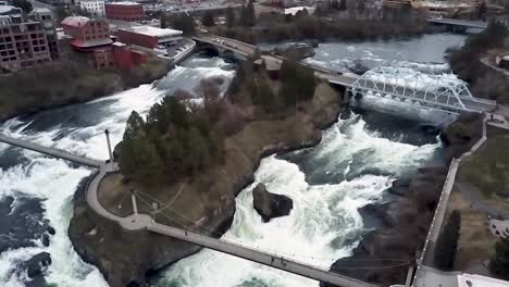 upper spokane falls of the spokane river flowing by canada island at cbd in downtown spokane, washington