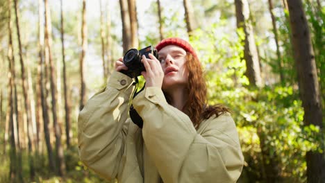 woman taking a picture in the forest