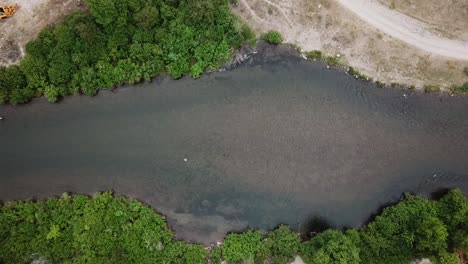 Lowering-Drone-Shot-above-a-man-Fly-Fishing-in-the-Provo-River-in-the-Mountains-of-Utah