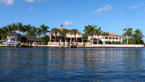 miami lake house with reflection and palm trees, establishing shot