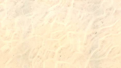 seamless loop repeat of sea water surface ripple on clear white beach sand