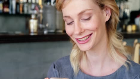 smiling woman is watching her phone