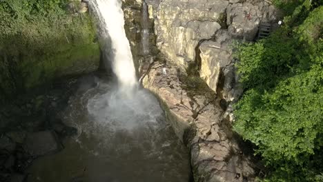 AERIAL-PEDESTAL-ON-WATERFALL,-Tegenungan,-beautiful-cascade-in-Bali,-Indonesia