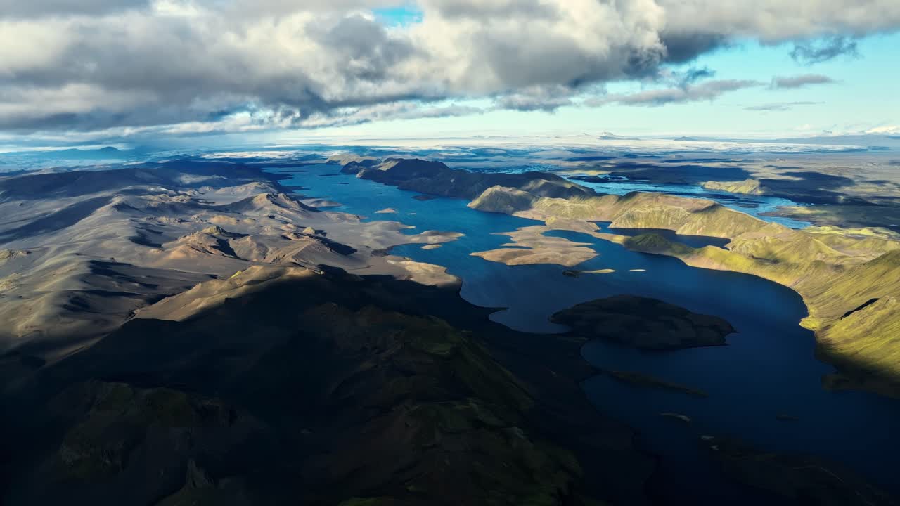 Sweeping aerial view of Iceland’s remote lakes and golden highlands, capturing a vast untouched wilderness ideal for cinematic travel stories and adventure journeys