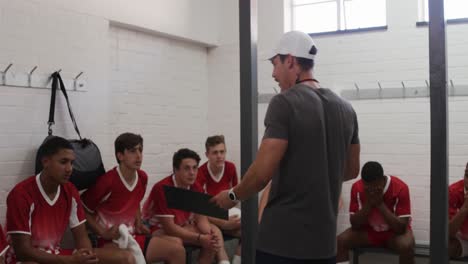 Coach-talking-to-rugby-players-in-the-locker-room