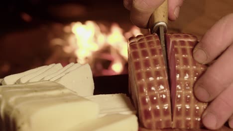 thick ham and cheese slices prepared on cutting board by hot camp fire