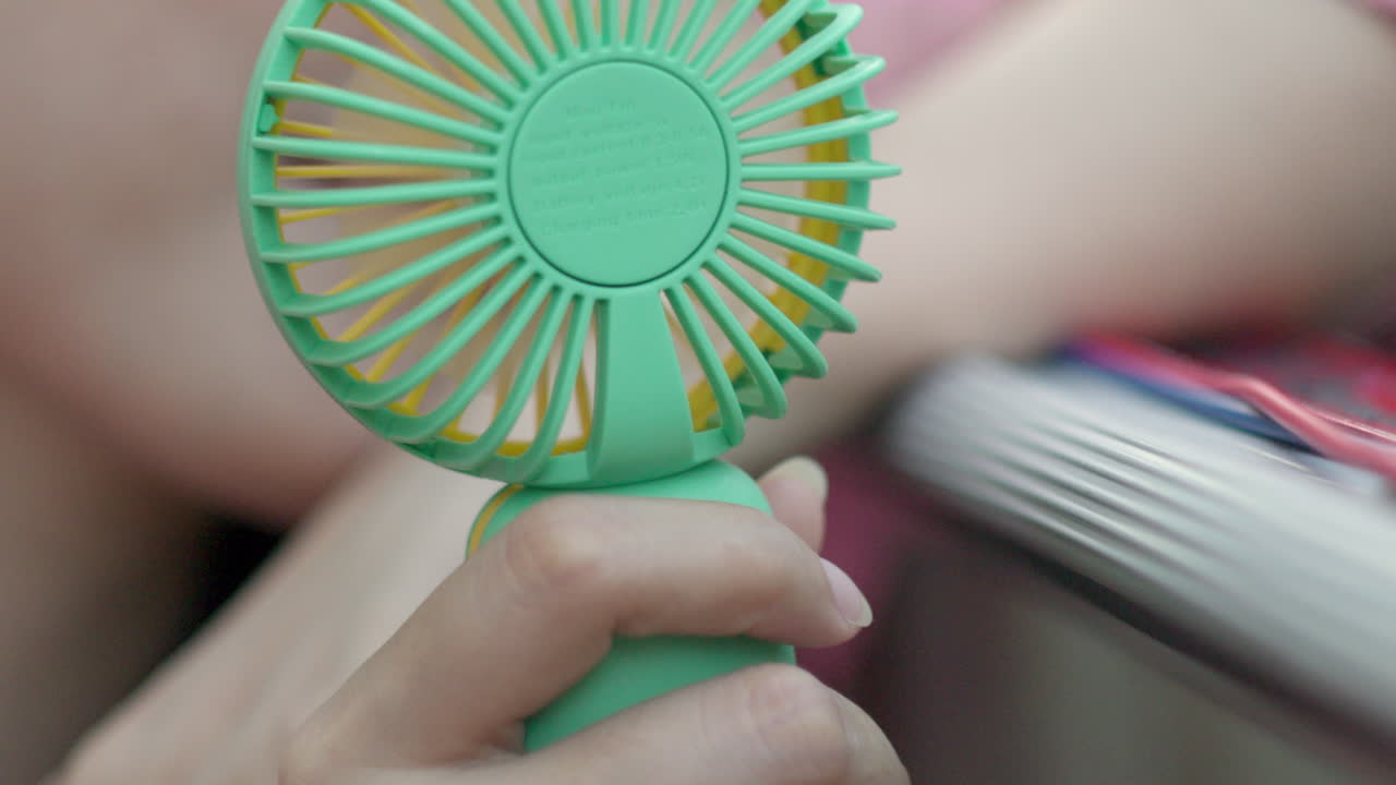 Close up of small mini fan girl woman searching refreshment cool air ...