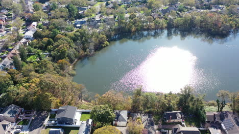 an aerial drone view of grant pond in a long island, ny suburb