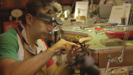 italian goldsmith at work building an engagement or a wedding ring