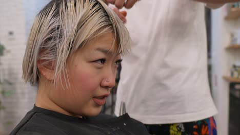 woman getting a haircut in a hair salon