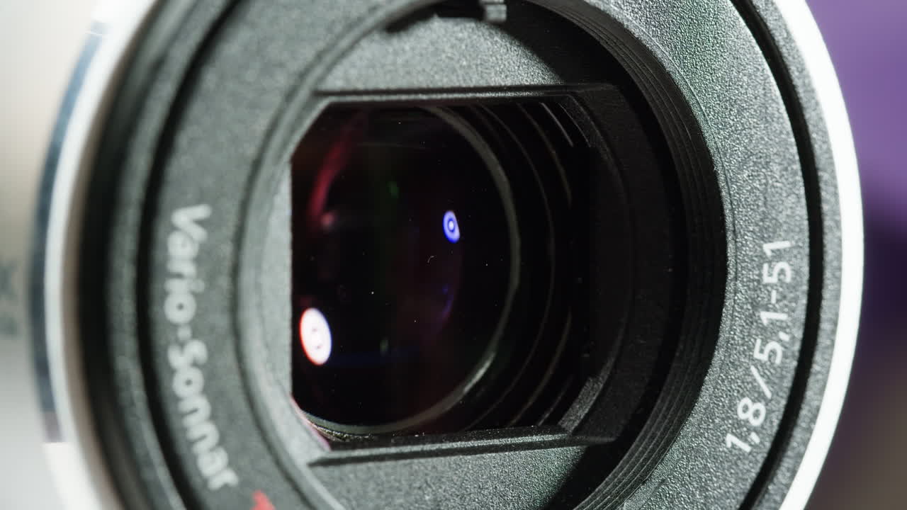 Close-up of Vintage video-camera. Close and open lens zoom of camera. Using portable camcorder to shooting videos