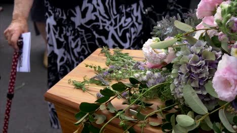 closeup shot of a funeral casket in a hearse or chapel or burial at cemetery