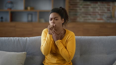 woman coughing on a couch