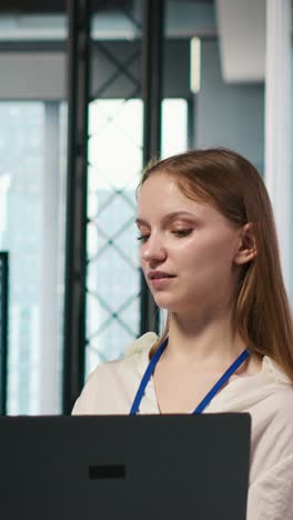 vertical video female engineer and coworker coding ai algorithms to debug software issues