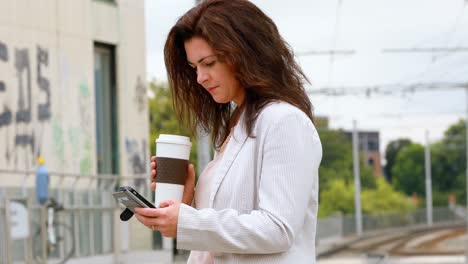 Woman-using-mobile-phone-at-railway-station-4k