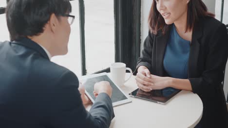 businessman and woman shaking hands after successful meeting