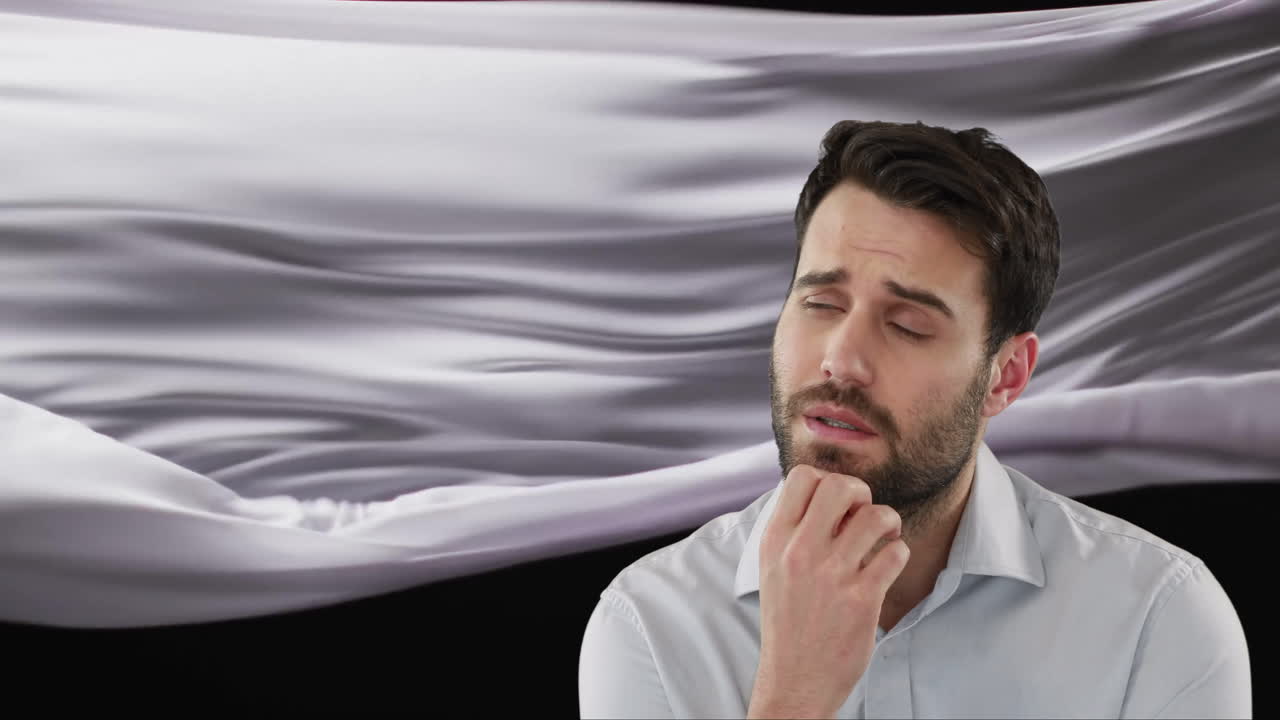 검은색 바탕에 떠다니는 천을 생각하고 있는 백인 남자의 애니메이션