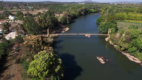 Cinematic-shot-of-wooden-Suspension-Bridge-hanged-over-famous-river-in-India