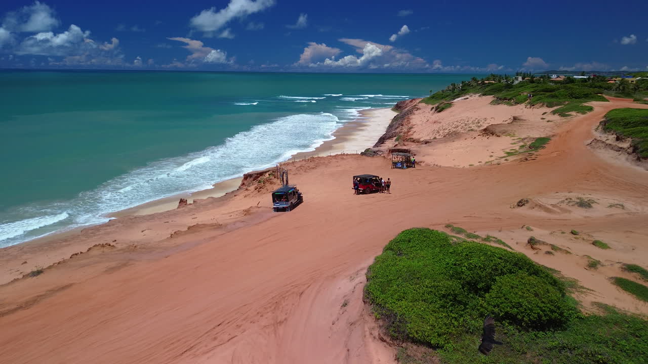 Aerial view following a off-road vehicle driving in Chapadao, sunny day in Brazil
