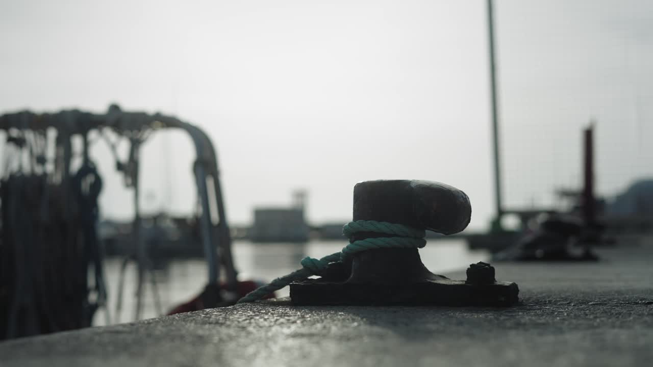 Coastal Town Port Detail with Rope Around a Mooring Bollard