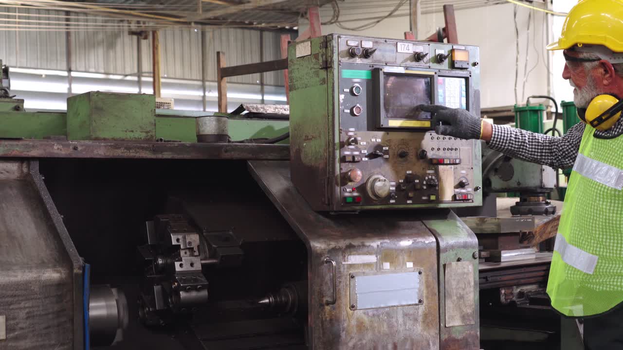 trabajador sénior de la fábrica enseña cómo usar el equipo de la máquina en el taller de la fábrica