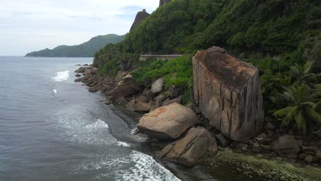 landscapes in seychelles showing the nature, maountains, ocean, sea, and massive granit rocks filmed from above with a drone in 4k with movement