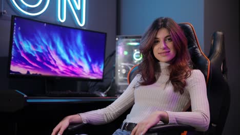 a woman deeply engaged in gaming while seated in a chair a woman is immersed in her gaming experience in a comfy chair navigating an engaging digital world on her monitor showcasing her enthusiasm