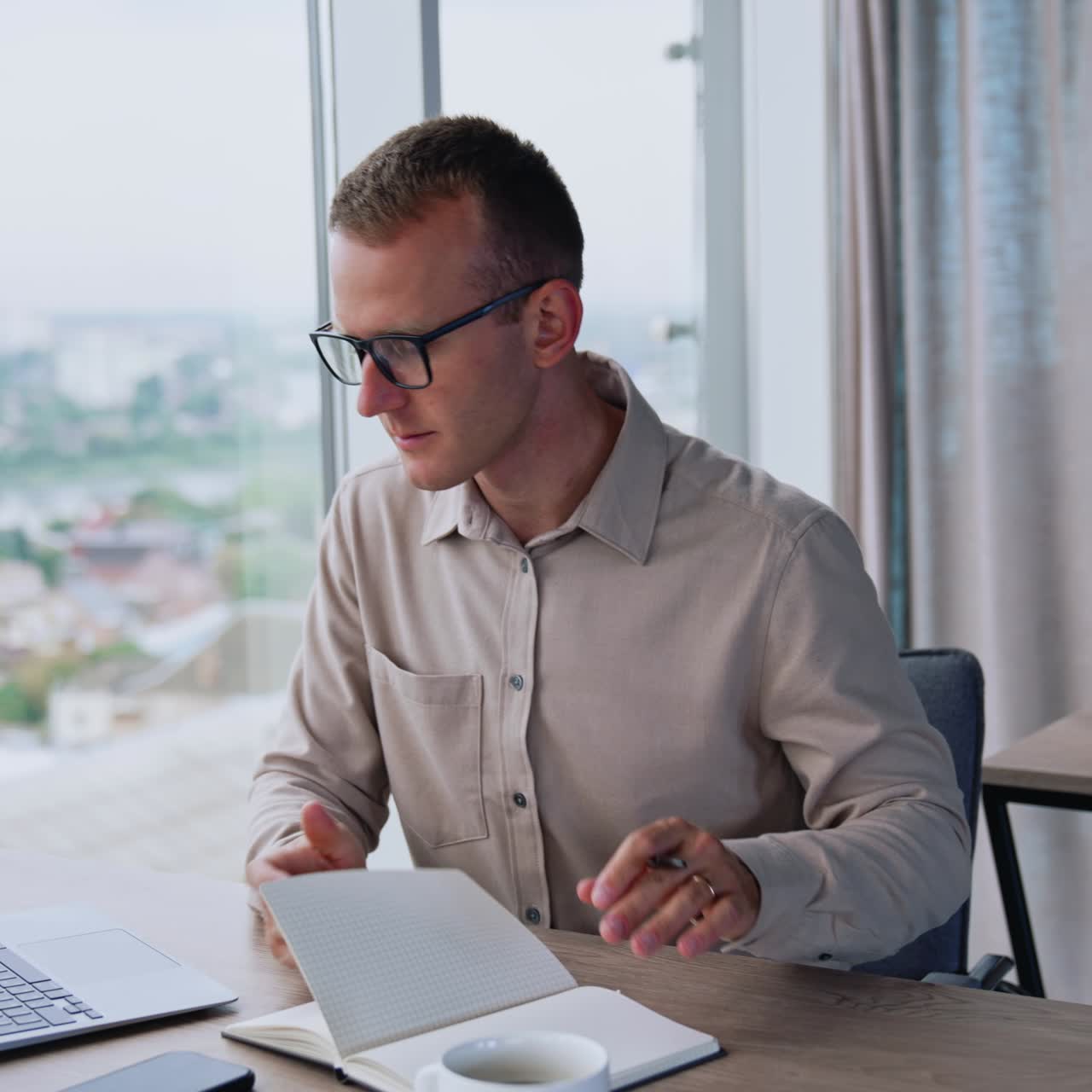 Succesfull businessman using a laptop in modern office room. Young confident business manager working with laptop in office