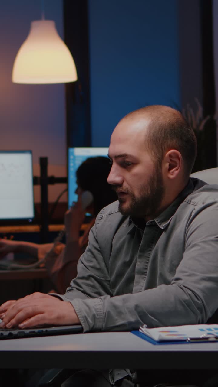 Vertical video Happy successful businessman enjoying while looking at laptop computer