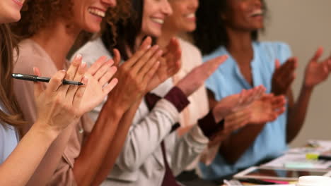 smiling women clapping hands