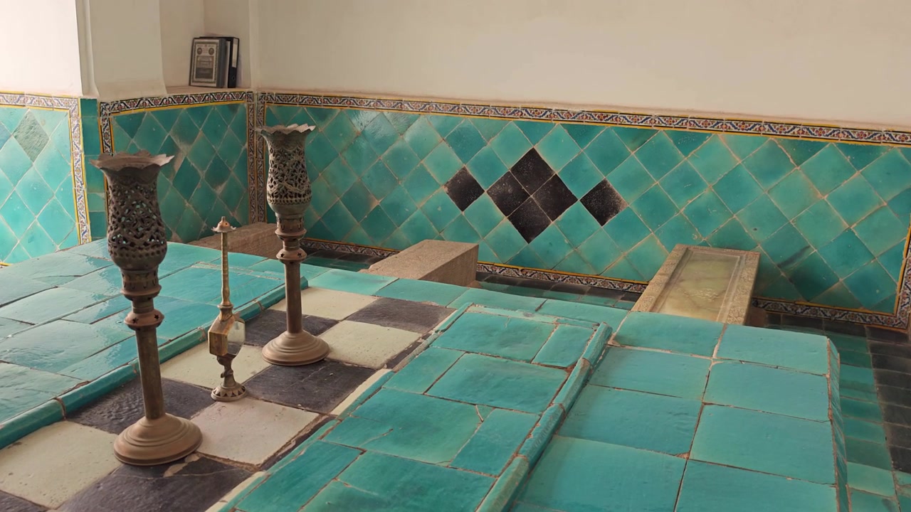 Ornate Turquoise Tiled Tomb Interior with Antique Metal Candle Holders