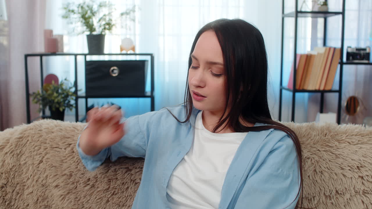 Woman suffering severe headache sitting holding head exhausted searching taking pain relief pills