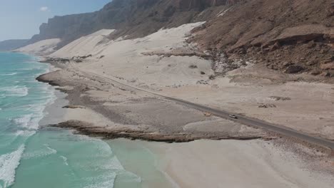 car stopped on the road of archer beach, socotra island