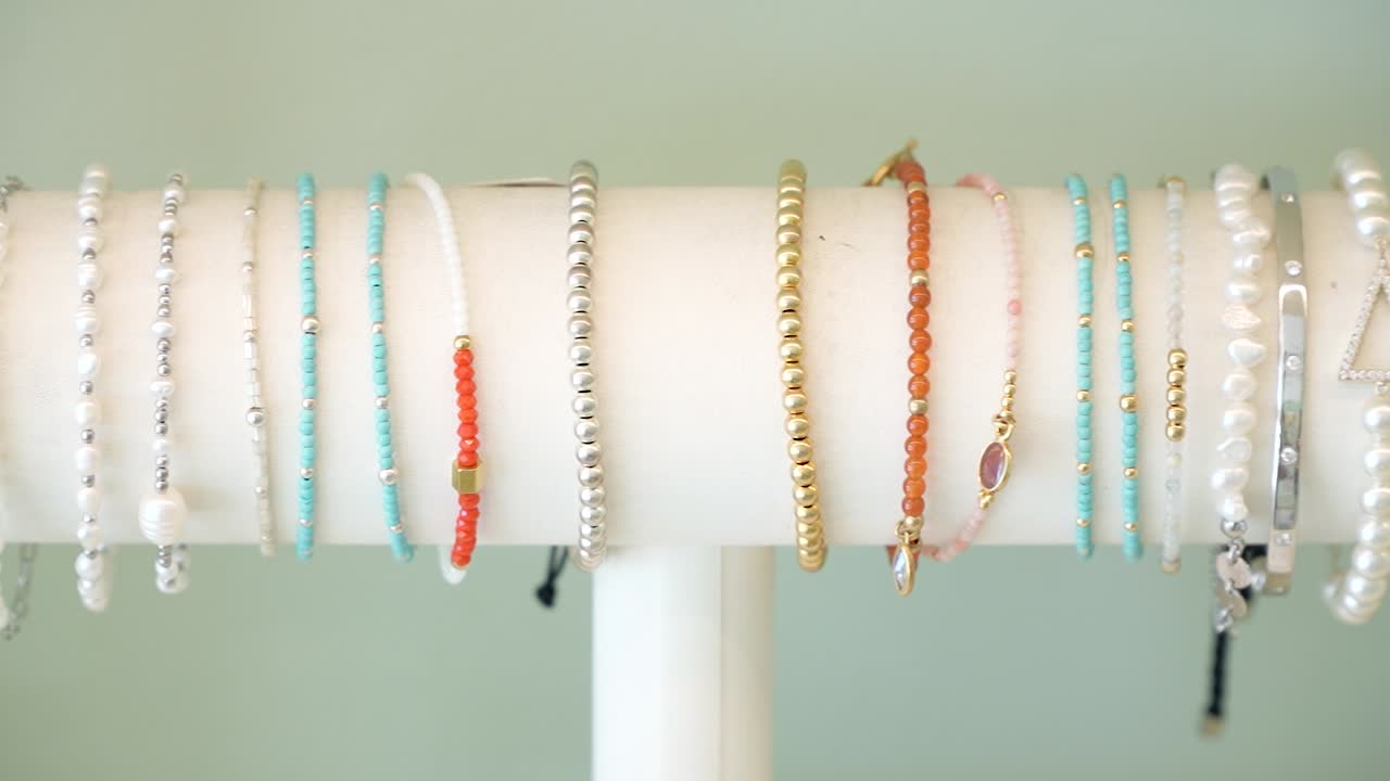 Strolling through a local craft fair, discover an array of beautiful handmade bracelets on display. Each piece showcases unique colors and designs, perfect for personal style