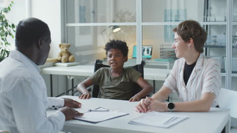 doctor consulting with patient and mother