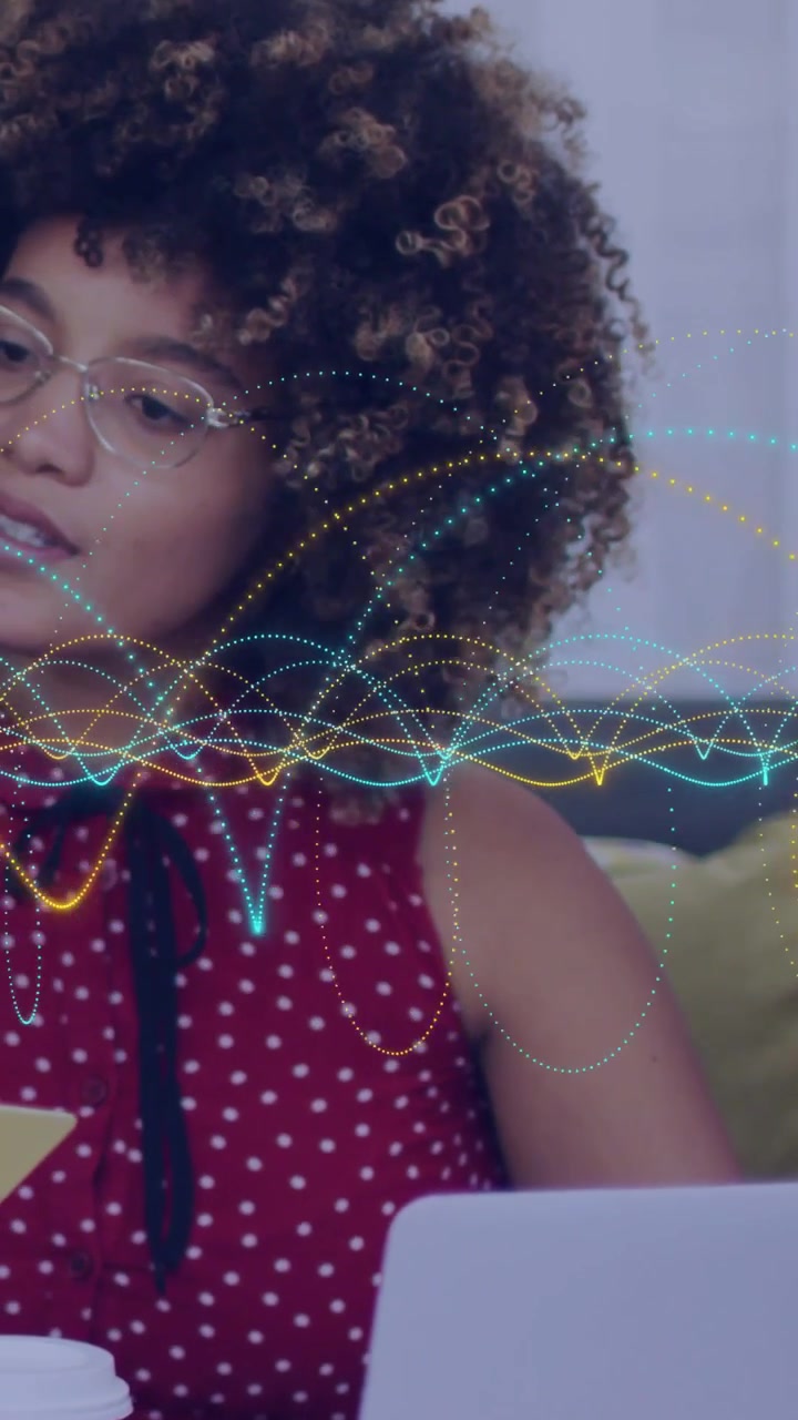 Waveform appearing midline starting woman glancing, typing, reaching coffee while working laptop