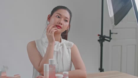 behind the scenes on photo shoot: beautiful asian model poses for a photographer
