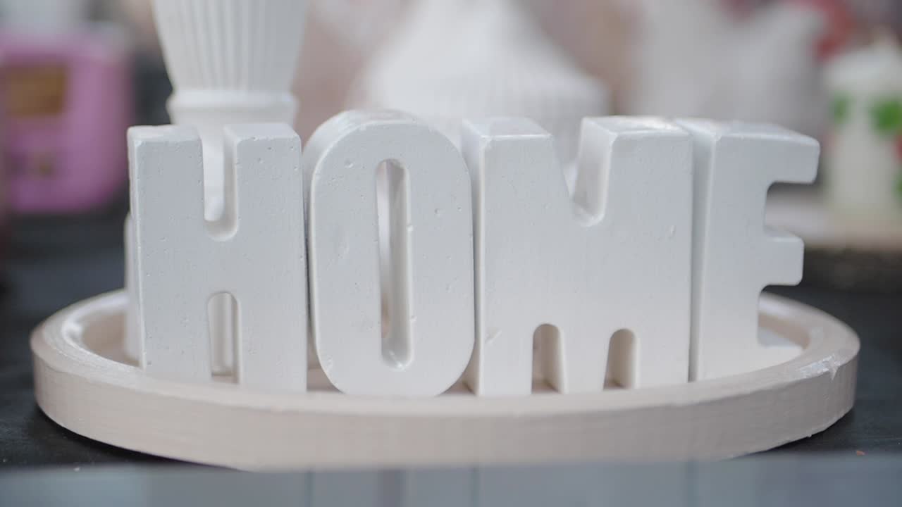 White Letters Spelling out Home on a Tray