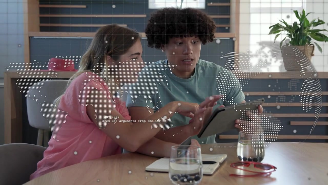 Woman pointing, man tapping tablet in tech meeting, overlay map updating as pair reviewing content